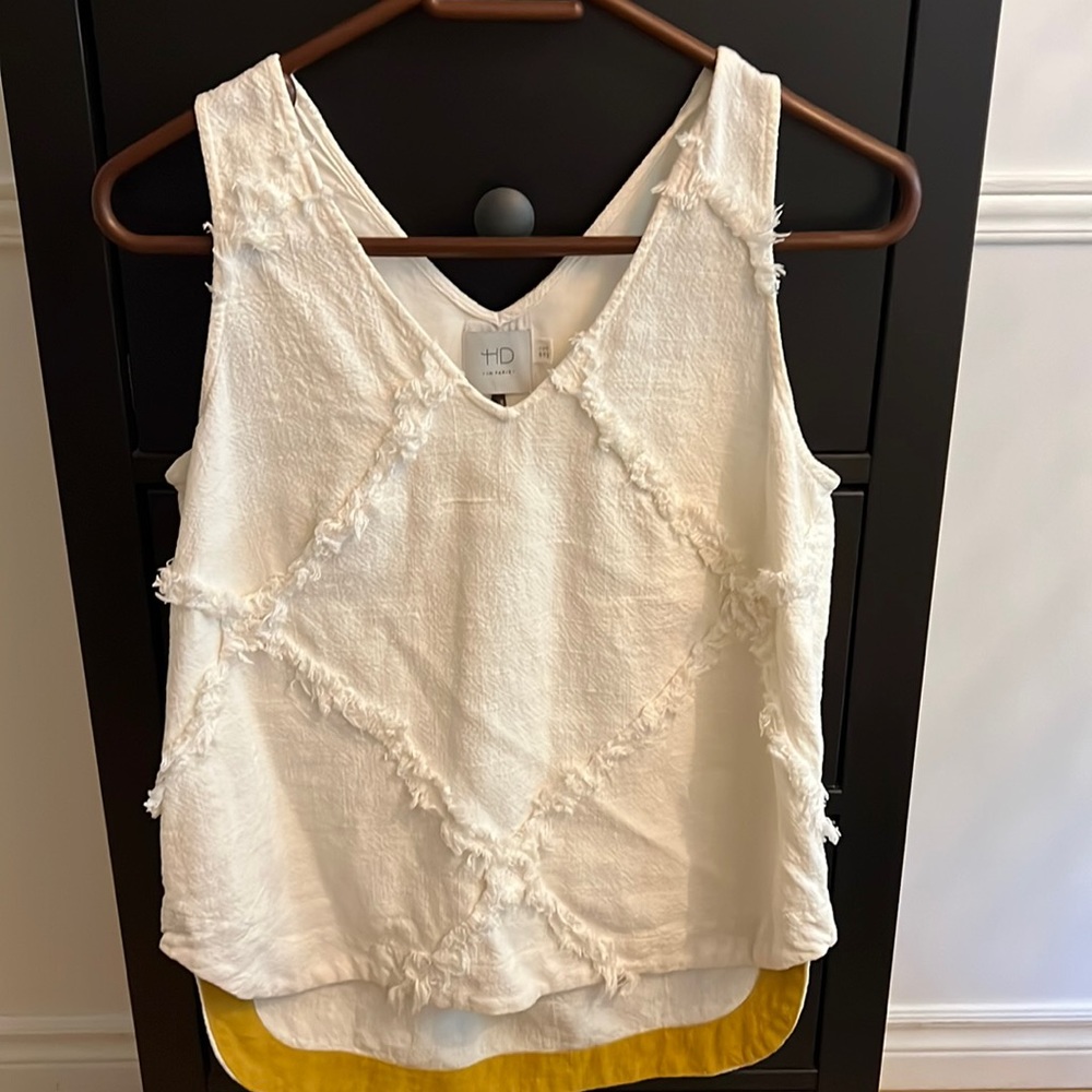 Sleeveless top with frayed pattern.